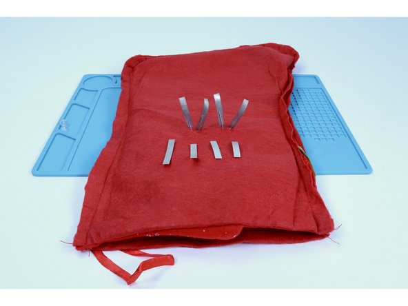 Measure and cut 2 pieces of Maker Tape PER LED leg (that's 8 TOTAL) that are each about as long as the LED legs themselves.