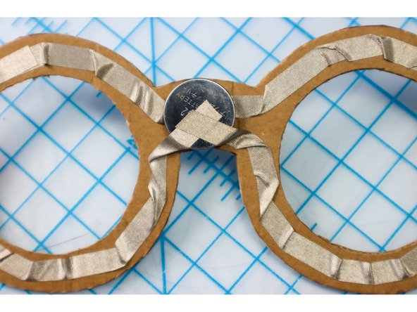 Repeat the same on the bottom, connecting the piece of Maker Tape to the top of the battery as shown.