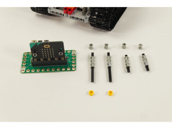 Slide 3 of the LEGO Bushing parts onto a LEGO Axle 8.