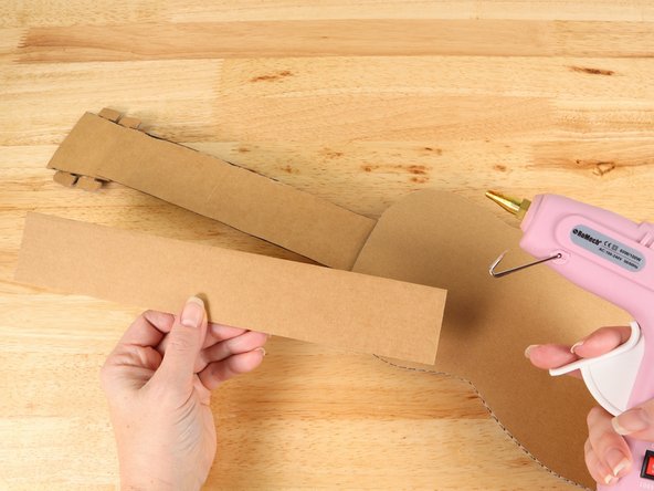 Flip the guitar over and glue the second neck to the back of the first neck. This will make the guitar stronger and more sturdy.