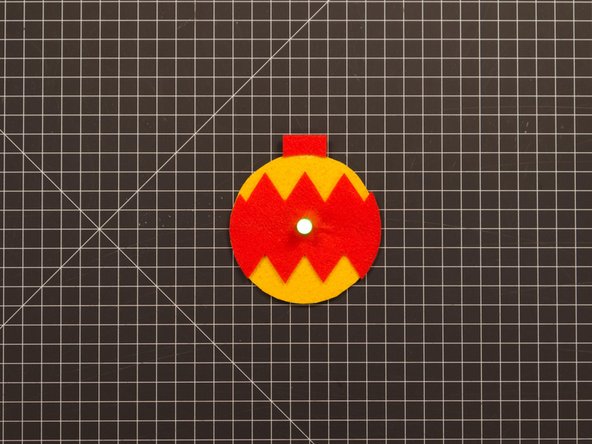 You can choose to glue the decoration down or just add some tape loops behind it to hold it in place.