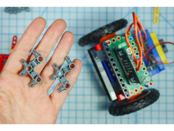 Add two 90-degree connectors to the back of each red frame as shown.