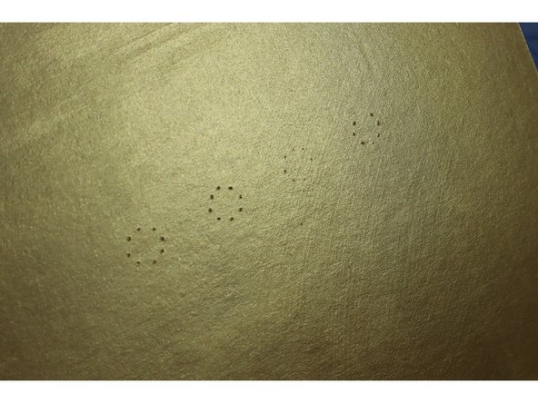 To cut the holes, we used a craft knife to mark the circles from the back side and then cut out the holes from the front.