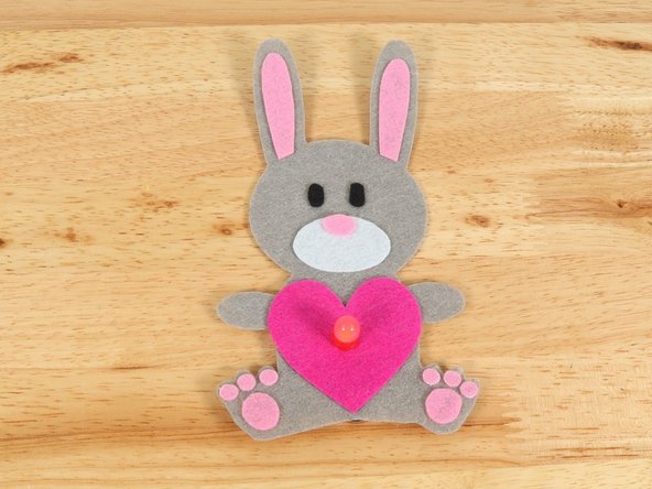 To make the Bunny look like it is holding the heart, fold the paws inward and keep them in place with a small amount of hot glue.