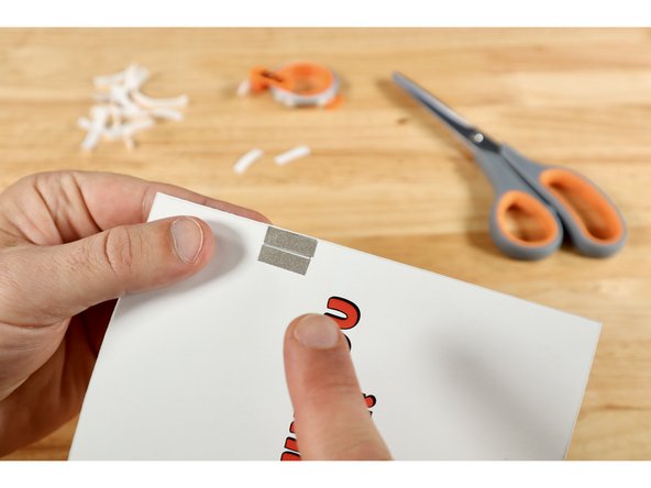 When the card is closed and the wing is pinched or pressed where indicated, the gap on the circuit side will be bridged by these two paths. Electric current will flow; lighting up the eyes for as long as these two parts are held in contact.