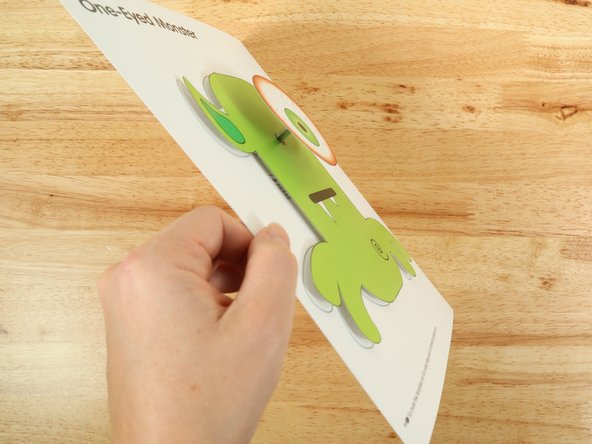 Add another square of double-sided tape onto the shaft of the motor, and then stick the eye to it.