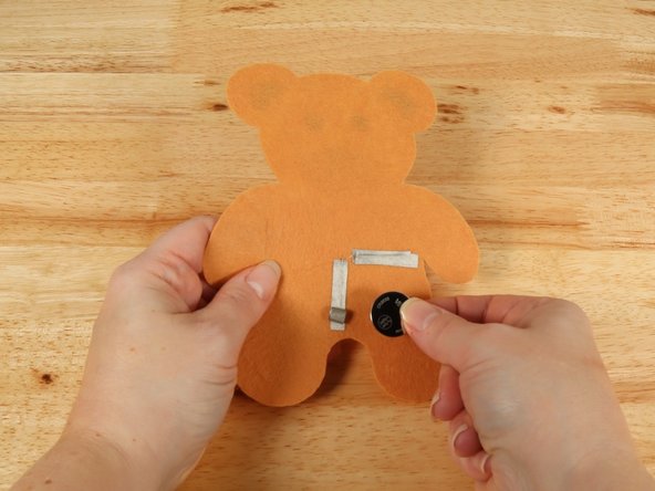 Make sure the Positive side of the Battery is facing upwards, with the Negative side stuck down to the tape.