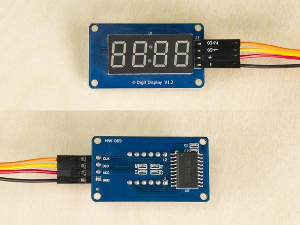 The 7 Segment Display has four pins. We'll connect the - wire to GND, the + wire to VCC, the S1 wire to DIO and the S2 wire to CLK.
