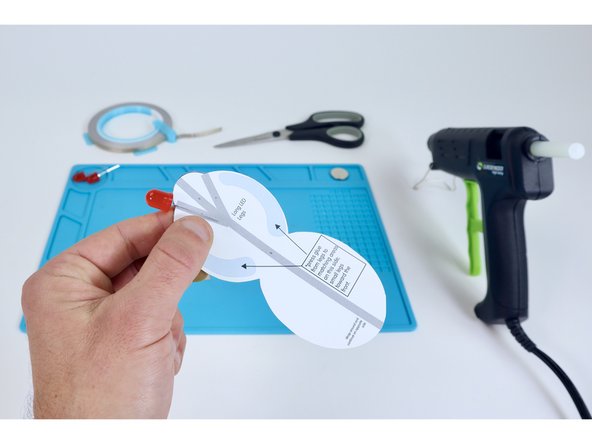 The long (+) legs from your three LEDS will need to lay flat against the side of the head (cephalothorax)  shown. Position the LED legs as shown and secure  each leg to the project with a strip of Maker Tape  (labeled “A,B,C,D,E,F” on your circuit diagram).