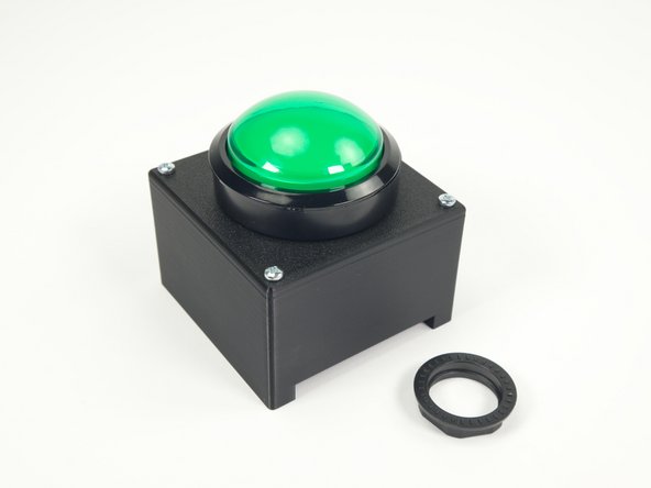 Insert the button through the hole on the top, and then screw the large plastic nut in place to secure the button.