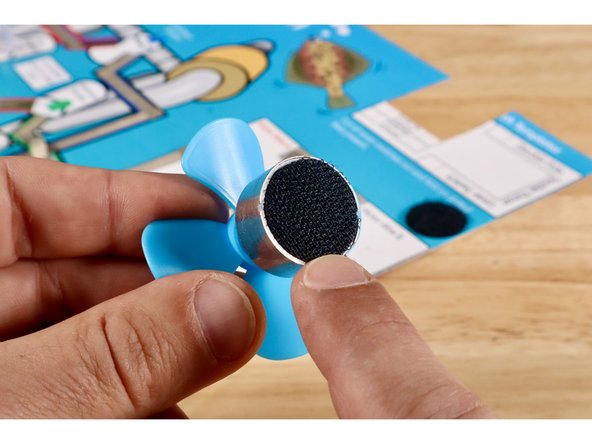 Peel and stick the hook half of that dot to the back of your motor.