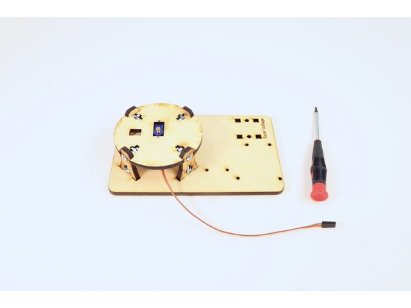 Use the four screws/nuts and your screwdriver to join the circular assembly to the plate.