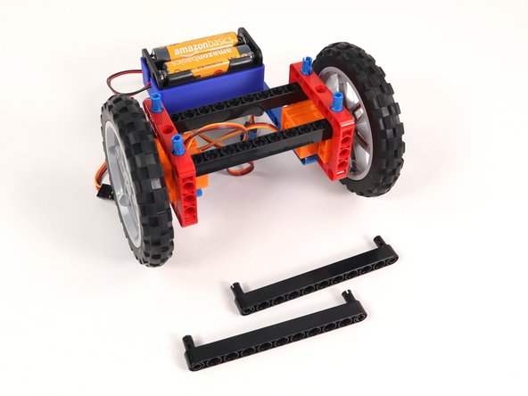 Remove the two long black beams on the front of the Rover as well as the black pins holding them in place.