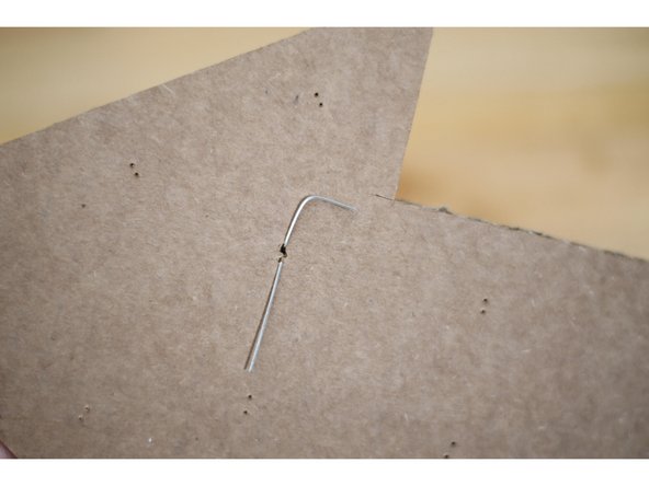 Bend the legs over to so they don't hang off the edge of the arrow.