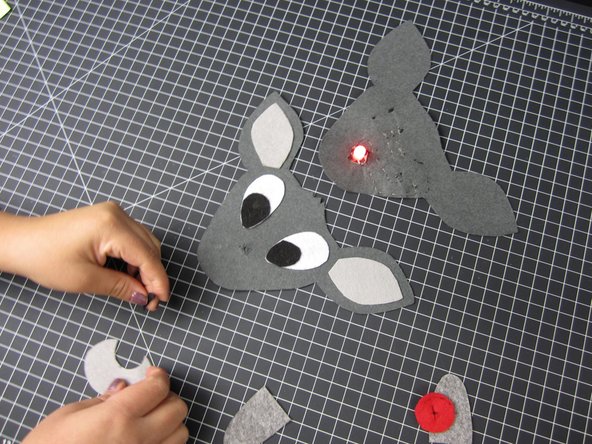 We cut slits into the red fabric for our LED to go through.