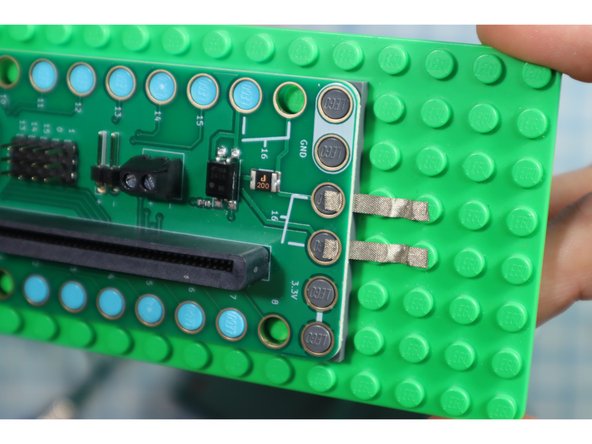 Connect two pieces of Maker Tape to Pin 16.