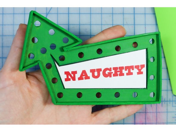 Glue the words behind the arrows, making sure not to cover the LED holes.