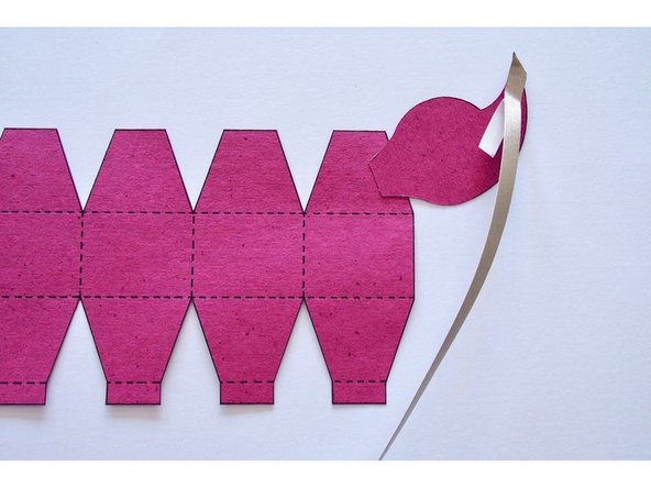 Cut a piece of Maker Tape that's a few inches longer than the tail.