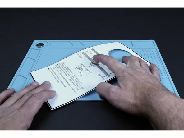 Stick the tape loop atop the middle point of the tape path that crosses the battery.