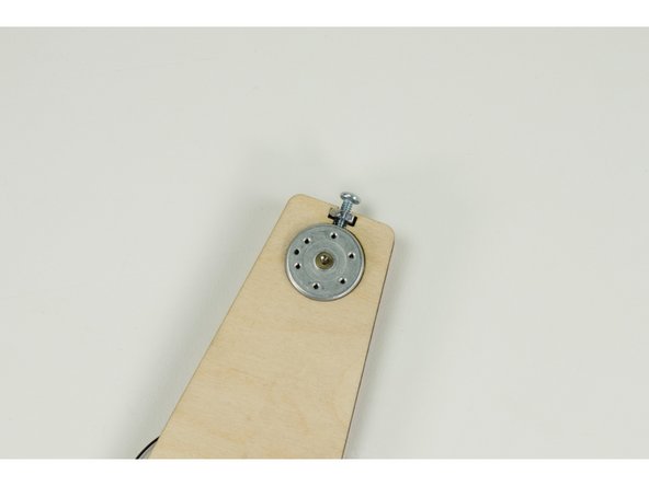 We want to make sure the attached wires on the back of the motor don't press up again the wood, and that they are oriented towards the bottom.