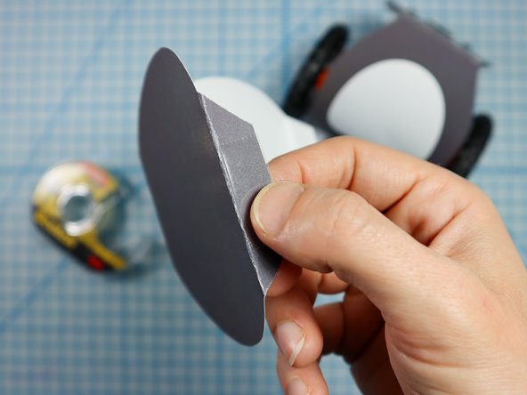 Stick double-sided tape or glue to the bottom of the head flaps.