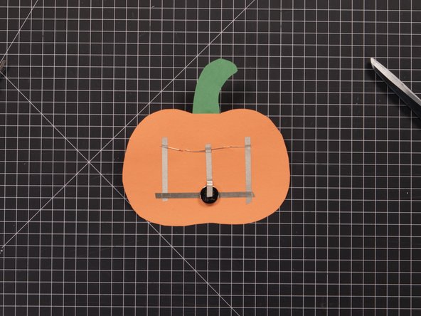 Finally, add one more piece of Maker Tape that connects the two longer (positive) LED legs to the top of the battery.