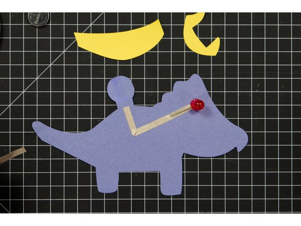 Run a piece of tape along the front of your Triceratops, covering the negative LED leg.