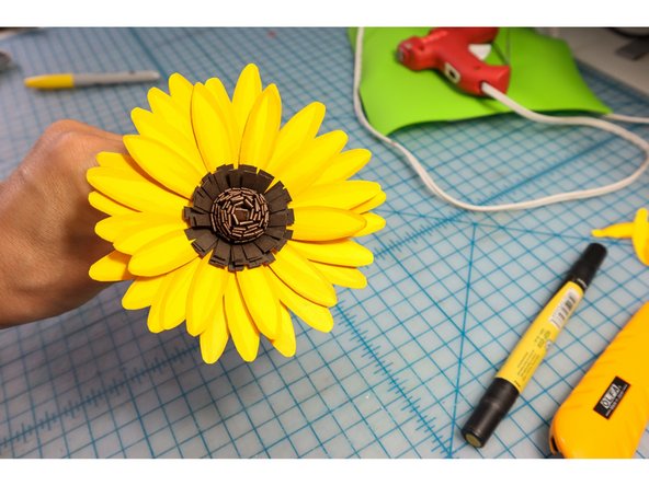 Glue the petals around the flower center. There should be enough to make about 3 rows.