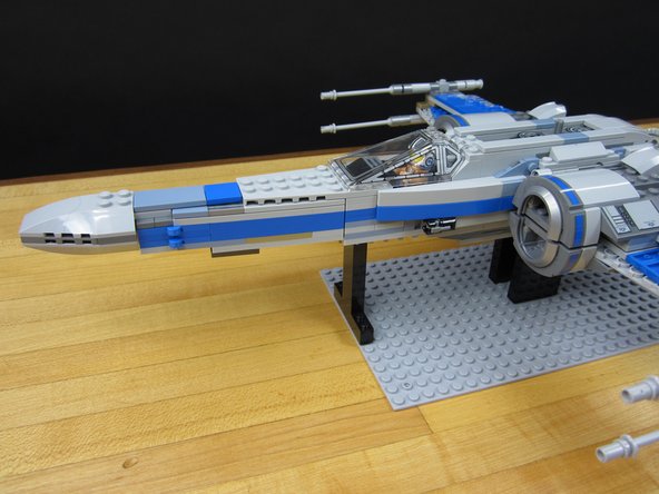 We used some tall 1x2x5 bricks (2454) to make supports. You can use whatever you want provided that it gives enough clearance for the wings and Servo.