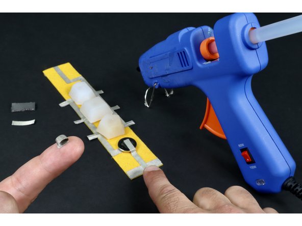 Peel one of the pieces of Maker Tape and roll it into a tape loop.