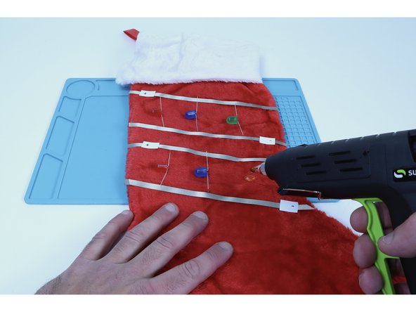 Make sure that the legs are able to reach and contact their respective paths and use a dab of hot glue to secure them in that position.