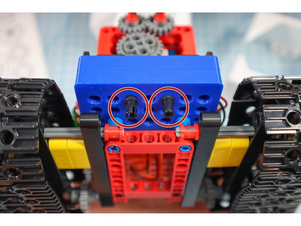 Add 2 pins to the front and 2 pins below the battery pack as shown. This will be where the paper body is attached.