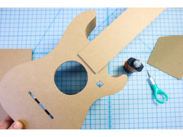 Glue the neck to the body. You can use the dotted line in the template as a reference for placement.