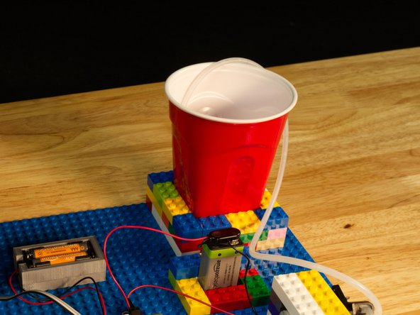 You'll need something to store and draw water from. We had a red plastic cup on hand and a bit more good luck - easily built a LEGO holder on our baseplate that fit it perfectly.