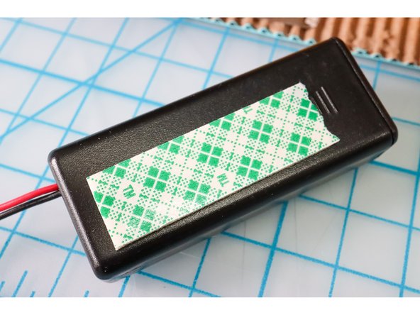 Use foam tape to mount the battery holder inside the guitar.