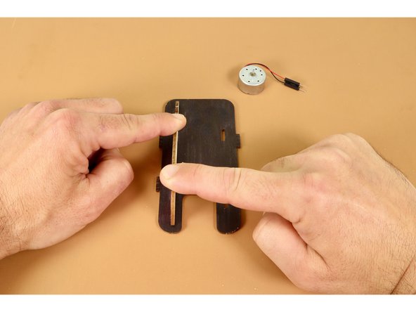 Lay the Solar Racer base plate flat against a table with the engraved side down and the u-shaped notch facing toward you.