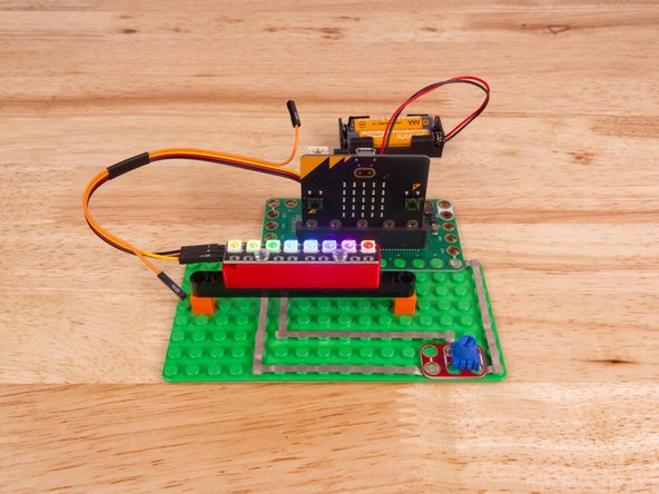 So let's get connected! If you turn the NeoPixel Strip over you'll see labels for the three pins. You should see IN, VCC, and GND.