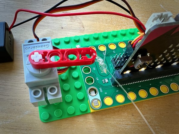 Tie the end to the motor head.