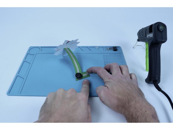 Use the remaining piece of Maker Tape to make another tape loop and place IT where shown in photo 3.