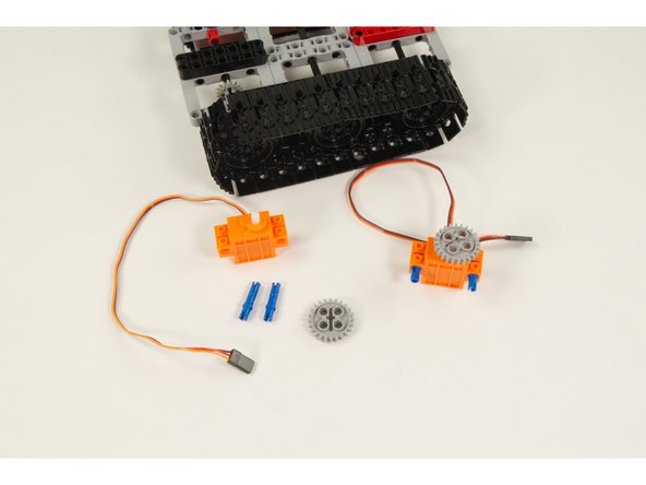 For each servo press a LEGO Gear with 24 Teeth into place on the servo shaft.