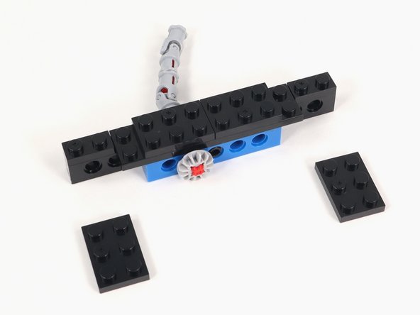 Attach (2) 2x3 plates in the center of Section 1 so they line up with the blue brick with holes.