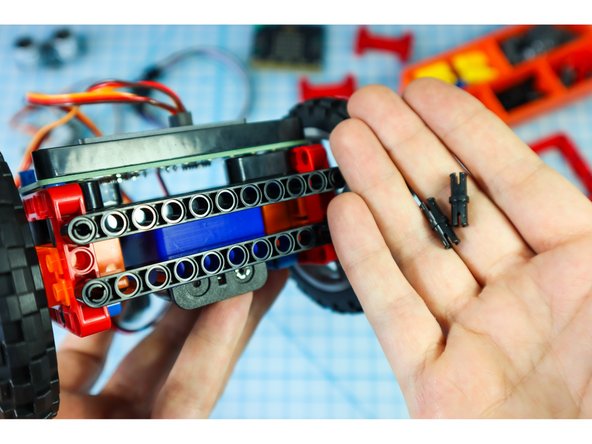 Add two pins to the front of the rover where shown.