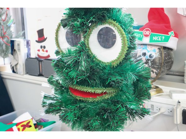 Use the pipe cleaners to attach the eyes and mouth to a Christmas tree. We used a 3-ft artificial tree.
