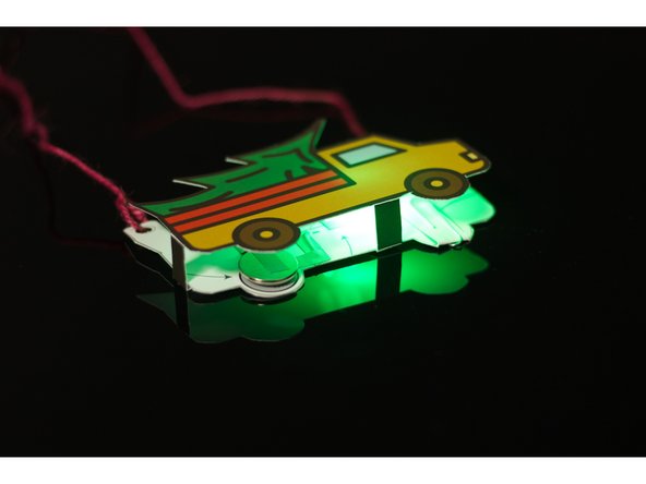 If you have a hole punch available it's the best tool to add holes to the tabs so you can add a string or lanyard and wear your badge.