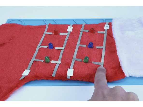 When finished, all of your LEDs legs should be electrically connected to the longer outer paths as pictured in photo 3.