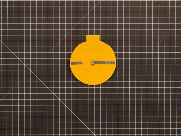 Add the tape loop to the end of the negative piece of tape.