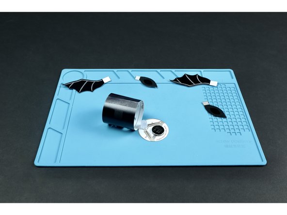 Stick the battery onto the tape loop so that the positive side faces UP.