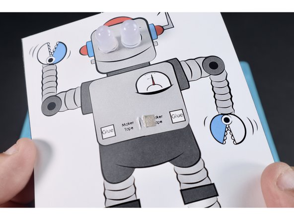 Stick that little section down atop the nearest of the two areas  labeled &quot;Maker Tape&quot;. When finished it should look like photo 3 and have the remainder of the tape path hanging out of the back side with the backing still on it.