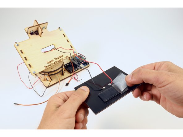 Peel the remaining backing from the velcro (now attached to the solar panel).