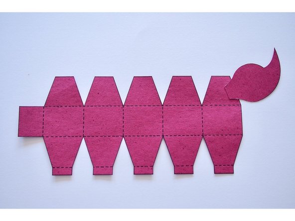 Glue one side of the stinger onto the tail as shown.